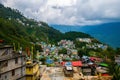 Drone view of Gangtok City with mountains covered with clouds and trees in Sikkim, India