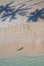 Drone view of girl and her shadow on beach Royalty Free Stock Photo