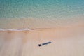 Drone view of girl and her shadow on beach Royalty Free Stock Photo