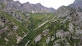 Drone view of a green gorge with high rocky cliffs