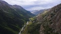Drone view of a green gorge with high rocky cliffs