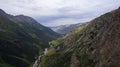 Drone view of a green gorge with high rocky cliffs