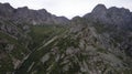 Drone view of a green gorge with high rocky cliffs