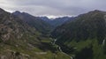 Drone view of a green gorge with high rocky cliffs