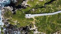 Drone view of a hiking path with a viewpoint in the green valley against the sea Royalty Free Stock Photo