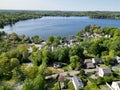 Drone view of Lake Attitash surrounded by greenery on a sunny day in Massachusetts