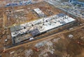 Drone view of a large construction site. Tower cranes in action on fog background. Housing renovation concept. Crane during Royalty Free Stock Photo