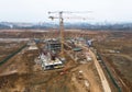 Drone view of a large construction site. Tower cranes in action on fog background. Housing renovation concept. Crane during Royalty Free Stock Photo