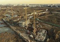 Drone view of a large construction site. Tower cranes in action on fog background. Housing renovation concept. Crane during Royalty Free Stock Photo