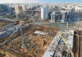 Drone view of a large construction site. Tower cranes in action on fog background. Housing renovation concept. Royalty Free Stock Photo