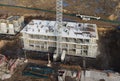 Drone view of a large construction site. Tower cranes in action. Housing renovation concept. Crane during formworks. Construction Royalty Free Stock Photo