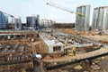 Drone view of a large construction site. Tower cranes in action. Housing renovation concept. Crane during formworks. Construction Royalty Free Stock Photo