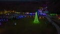 Drone View of Large Drive Thru Christmas Display, With Lots of Colored Lights, Trees, and Landscapes