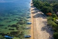 Drone view of lines of traditional outrigger boats off a sandy tropical beach (Sanur, Bali Royalty Free Stock Photo