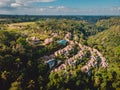 Drone view of luxury hotel with straw roof villas and pools in tropical jungle. Luxurious villa, pavilion in forest, Ubud, Bali Royalty Free Stock Photo