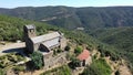 Scenic aerial view of ancient Romanesque building of Serrabone Priory in foothills of Canigou in summer, Pyrenees