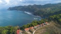 Drone view of Menganti Beach, Kebumen, Indonesia, beautiful beach with white sand, calm waves, coral cliffs and green trees Royalty Free Stock Photo