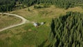 Drone view mountain barn road path among green spruce trees sunny warm day Royalty Free Stock Photo