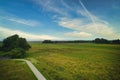 Drone view of nature near the river Vecht, green grass, trees, beautiful blue sky and bicycle path through the Vechtdal