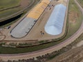 Drone view over grain storage piles being filled and covered