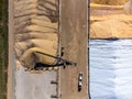 Drone view over grain storage piles being filled and covered