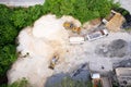 Drone view over sand quarry with heavy machinery.The truck and excavator.The truck drives up to the excavator for sand and crushed Royalty Free Stock Photo