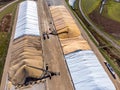 Drone view over grain storage piles being filled and covered