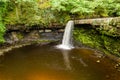 Drone view of a waterfall and pool in a narrow canyon and green forest Sgwd Gwladys, Brecon Beacons, Wales Royalty Free Stock Photo