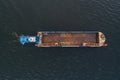 Drone view of a powerful tugboat pushing a large empty barge with a rusty deck across the Baltic Sea Royalty Free Stock Photo