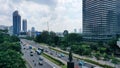 Drone view of quiet traffic on Sudirman road with skyscrapers in Jakarta city