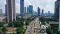 Drone view of quiet traffic on Sudirman road with skyscrapers in Jakarta city