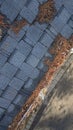 Aerial drone view of residential rain gutter eavestrough filled with pine needles and tree debris