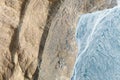 Drone view of the river in the glacier valley. View of the moraines. Landscape from the air. River on a moraine.