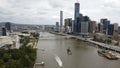 Drone view of riverside buildings and roads before the cloudy skyline in Brisbane