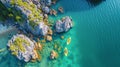 Drone view on rocks and canoes floating on turquoise water