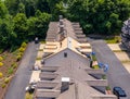 Drone view of roofing contractor removing shingles from a roof ready for reroofing