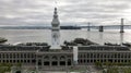 Drone view of San Francisco skyline with historic Ferry Building and Oakland Bay Bridge, California