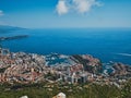 Drone view of a seascape of the port in Monaco city with residential buildings on the shore
