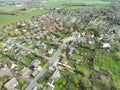 Drone view of a sprawling East Anglian village showing the main roadway leading through the bottom left of the image. Royalty Free Stock Photo