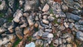 Drone view stone coast washing by stormy ocean water. Rocky dangerous seashore