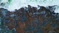 Drone view stormy ocean surf crashing volcanic seaside. Foamy sea waves coast