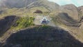 Drone view to a monument on top of a mountain. Clouds moving in sky about Kelimutu volcano crater aerial view, Indonesia Royalty Free Stock Photo