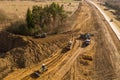 Drone view of trucks, bulldozer and road repair work in rural landscape