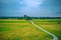 Drone view of the Vecht, green grass, blue water, bicycle path runs with an arc through the lawn. Vechtdal, Dalfsen Netherlands