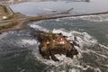 Drone view of waves crashing against rocks at Battery Point Lighthouse Royalty Free Stock Photo