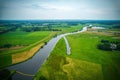 Drone view of the winding river Vecht, green grass, blue water, yellow buoys in the water. Vechtdal, Dalfsen the