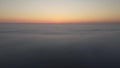 A drone watches the sunrise over the fog. Time lapse of morning autumn fog. Royalty Free Stock Photo