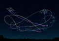 Drones create vibrant, multicolored light trails against a clear night sky. These trails Royalty Free Stock Photo