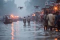 Drones flying over people walking in a flooded street with makeshift structures and lights Royalty Free Stock Photo