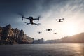 Drones flying over urban city square at sunset Royalty Free Stock Photo